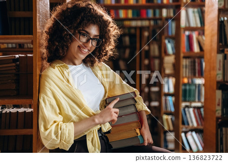 Beautiful woman is in the library Beautiful woman is in the library 136823722
