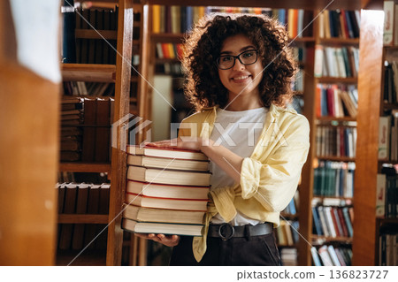 Beautiful woman is in the library Beautiful woman is in the library 136823727
