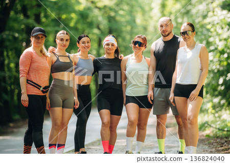Posing, looking forward. Group of runners are together outdoors 136824040
