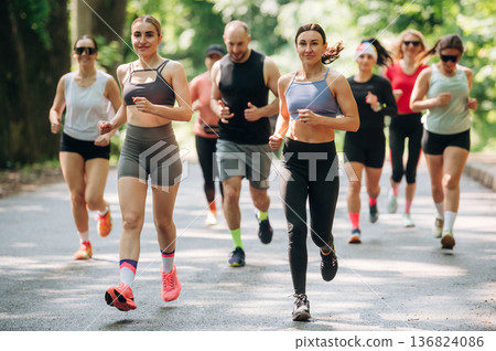 Marathon conception, front view. Group of runners are together outdoors 136824086