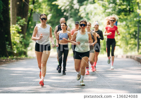 Marathon conception, front view. Group of runners are together outdoors 136824088