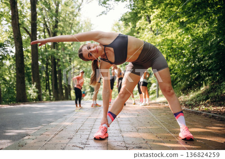Warm up exercise. Group of runners are together outdoors Warm up exercise. Group of runners are together outdoors 136824259