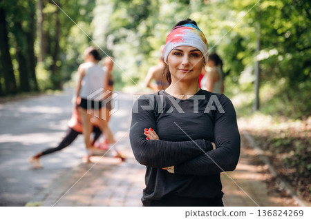 Posing, looking forward. Group of runners are together outdoors Posing, looking forward. Group of runners are together outdoors 136824269