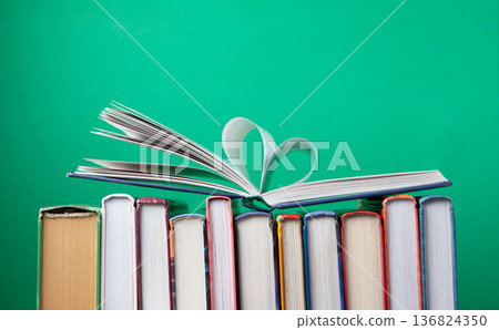 World Book and Copyright Day education concept with stacked books on green background. Intellectual work, publishing culture, protected knowledge 136824350