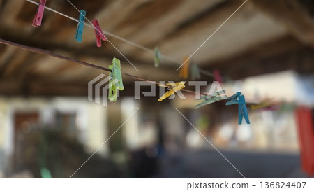 Colorful clothespins on a line in rustic outdoor setting Colorful clothespins on a line in rustic outdoor setting 136824407