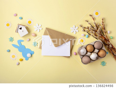 Easter spring  holiday card. Playful bunny, painted eggs, willow branches, paper flowers, decorative elements on yellow background 136824498
