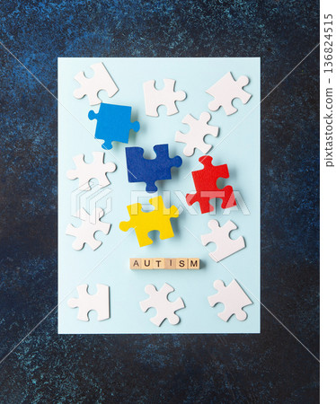 Autism Awareness Day design with colorful and white puzzle pieces on blue background, simple symbolic layout. support and understanding, top view, space for text. Autism Awareness Day design with colorful and white puzzle pieces on blue background, simple symbolic layout. support and understanding, top view, space for text. 136824515