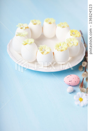 Easter spring  holiday card. Playful bunny, painted eggs, willow branches, spring flowers, decorative elements on light blue background 136824523