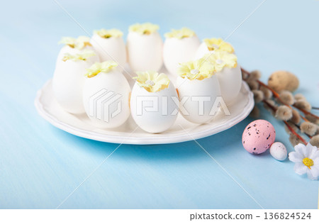 Easter spring  holiday card. Playful bunny, painted eggs, willow branches, spring flowers, decorative elements on light blue background 136824524
