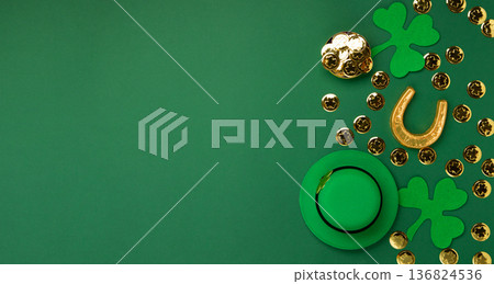 St. Patrick's Day Leprechaun Hat, Gold Coins, Shamrocks and Party Favors on Green Background. 136824536