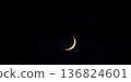 Crescent moon floating in the night sky 136824601