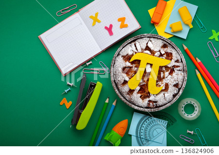 World Pi day. Baked apple pie with Pi Symbol and stationery, green background. March 14th (3/14). Mathematical constant. World Pi day. Baked apple pie with Pi Symbol and stationery, green background. March 14th (3/14). Mathematical constant. 136824906