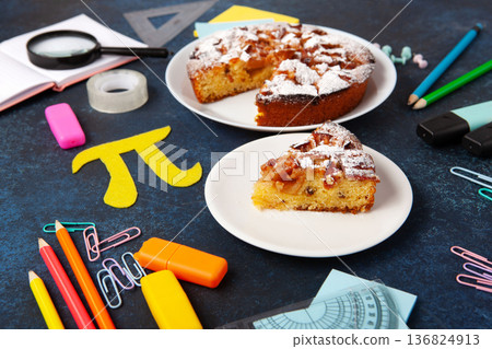 International World Pi day. Baked apple pie with Pi Symbol and stationery, dark blue background.   March 14th 3,14. Mathematical constant. 136824913