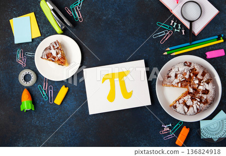 World Pi day. Baked apple pie with Pi Symbol and stationery, dark blue background. March 14th 3.14. Mathematical constant. World Pi day. Baked apple pie with Pi Symbol and stationery, dark blue background. March 14th 3.14. Mathematical constant. 136824918