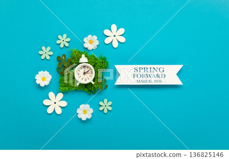 Daylight saving Time, Spring forward, Summer back concept. White Alarm Clock and Spring Daisy Flowers on Blue Background 136825146