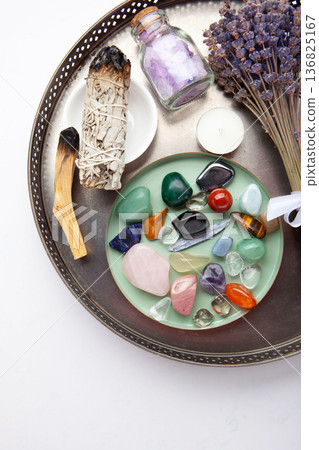 Chakra Crystal Healing Ritual With Lavender Palo Santo White Sage Essential Oils And Candles On White Marble Background 136825167
