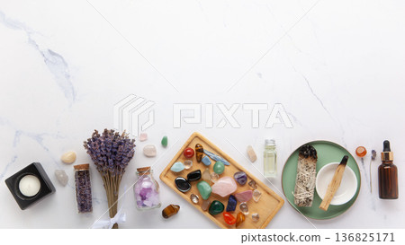 Chakra Crystal Healing Ritual With Lavender Palo Santo White Sage Essential Oils And Candles On White Marble Background 136825171