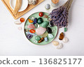 Chakra Crystal Healing Ritual With Lavender Palo Santo White Sage Essential Oils And Candles On White Marble Background 136825177