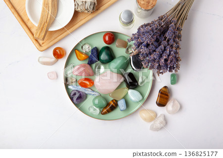 Chakra Crystal Healing Ritual With Lavender Palo Santo White Sage Essential Oils And Candles On White Marble Background 136825177