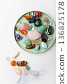 Healing chakra crystals on white marble background, minimal ritual layout symbolizing energetic power, wellbeing and mental balance 136825178