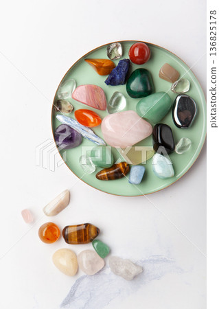 Healing chakra crystals on white marble background, minimal ritual layout symbolizing energetic power, wellbeing and mental balance Healing chakra crystals on white marble background, minimal ritual layout symbolizing energetic power, wellbeing and mental balance 136825178