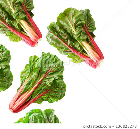 Fresh rainbow Swiss chard leaves with vivid red and yellow stems arranged in a seamless pattern isolated on white background 136825278