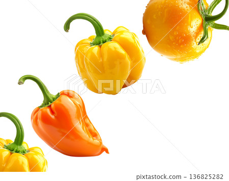 Fresh yellow and orange peppers with a dewy yellow tomato, isolated on white background, concept of healthy organic food Fresh yellow and orange peppers with a dewy yellow tomato, isolated on white background, concept of healthy organic food 136825282