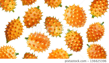 Multiple horned orange kiwano fruits with green tips isolated on white background, concept of exotic fruit freshness 136825396