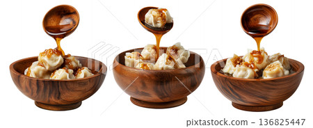 Steamed Faikakai dumplings topped with soy-based glaze, coconut syrup and sesame seeds in wooden bowl on white background Steamed Faikakai dumplings topped with soy-based glaze, coconut syrup and sesame seeds in wooden bowl on white background 136825447