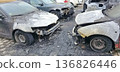 Burned and severely damaged cars parked in a lot after a fire incident. 136826446