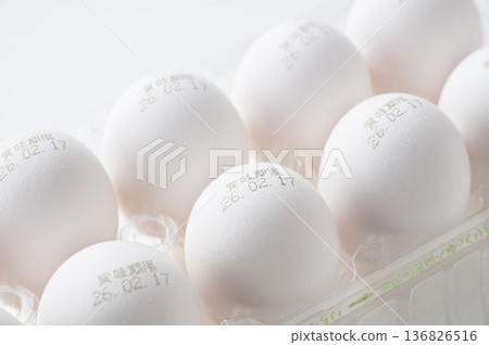 White raw eggs with expiration dates printed on them 136826516