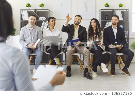 Diverse group of professionals engaged in interactive discussion in office Diverse group of professionals engaged in interactive discussion in office 136827180