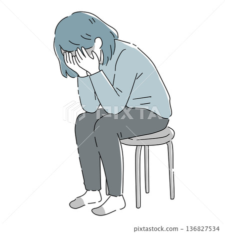 Depressed woman sitting on a chair Depressed woman sitting on a chair 136827534