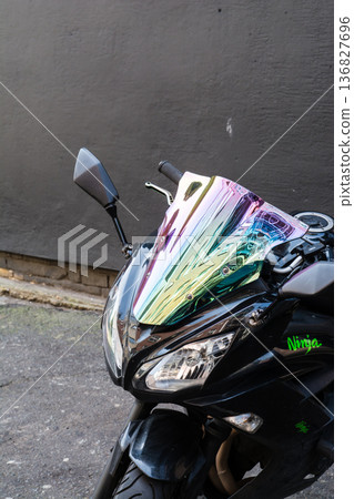 A sports bike with the colours of the buildings reflected on the windscreen in Shoreditch, East London A sports bike with the colours of the buildings reflected on the windscreen in Shoreditch, East London 136827696