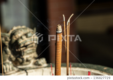 Temple incense burners, stone lions, and wisps of incense smoke Temple incense burners, stone lions, and wisps of incense smoke 136827729