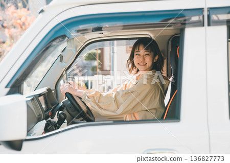 A housewife riding a light van 136827773