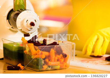 Make vegetables juice in juicer machine Make vegetables juice in juicer machine 136828227