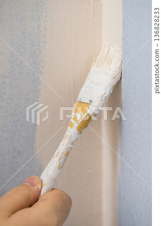 Person applying paint on wall Person applying paint on wall 136828233
