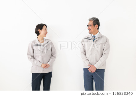 Men and women in work clothes Men and women in work clothes 136828340