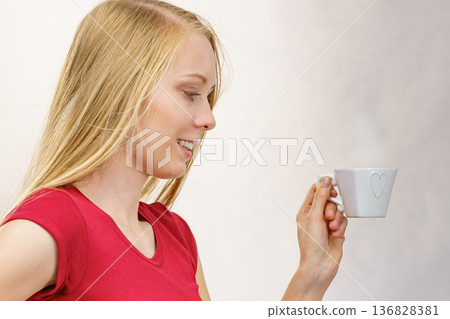 Blonde girl with coffee cup Blonde girl with coffee cup 136828381