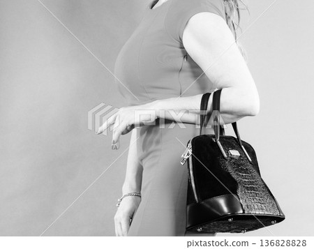 Part body of elegant woman with bag. 136828828