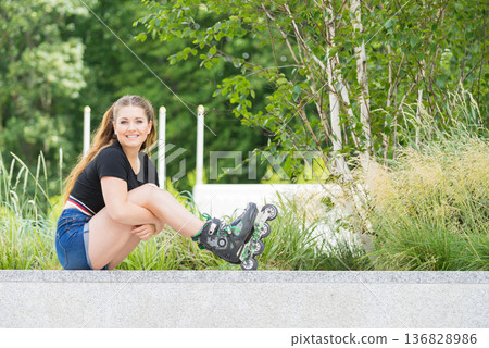 Young woman riding roller skates Young woman riding roller skates 136828986