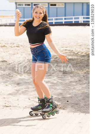 Roller skate woman eating ice cream Roller skate woman eating ice cream 136829010