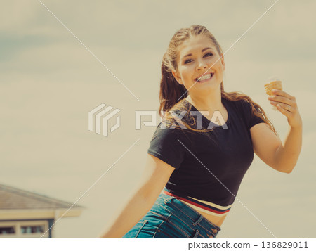 Young woman eating ice cream Young woman eating ice cream 136829011