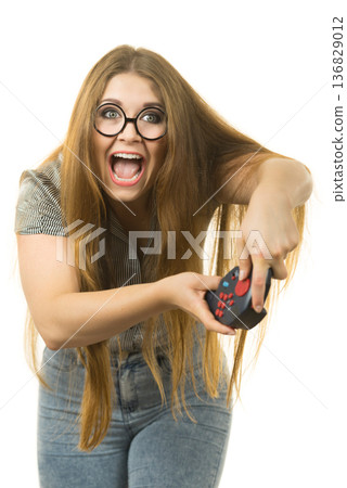 Gamer woman holding gaming pad Gamer woman holding gaming pad 136829012