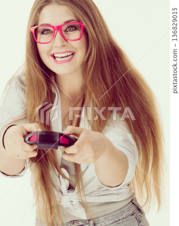 Gamer woman holding gaming pad Gamer woman holding gaming pad 136829015