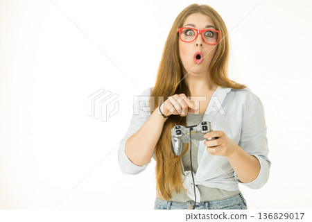 Woman trying to understand gaming pad 136829017