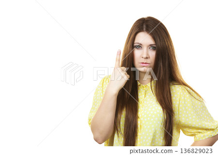 Serious woman being mad pointing 136829023