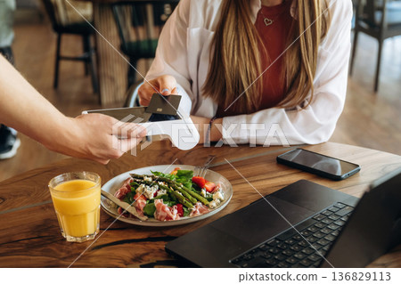 Wireless payment by using smartphone. Woman n the cafe restaurant Wireless payment by using smartphone. Woman n the cafe restaurant 136829113