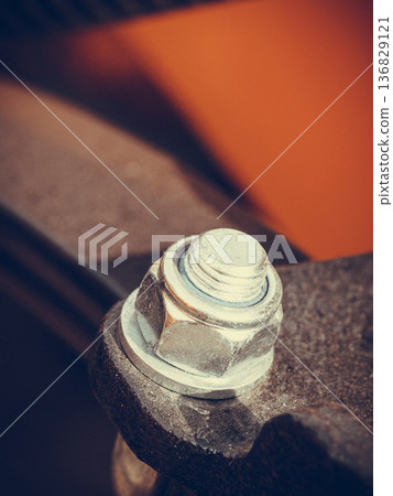 Detailed closeup of screw on indrustrial machinery 136829121